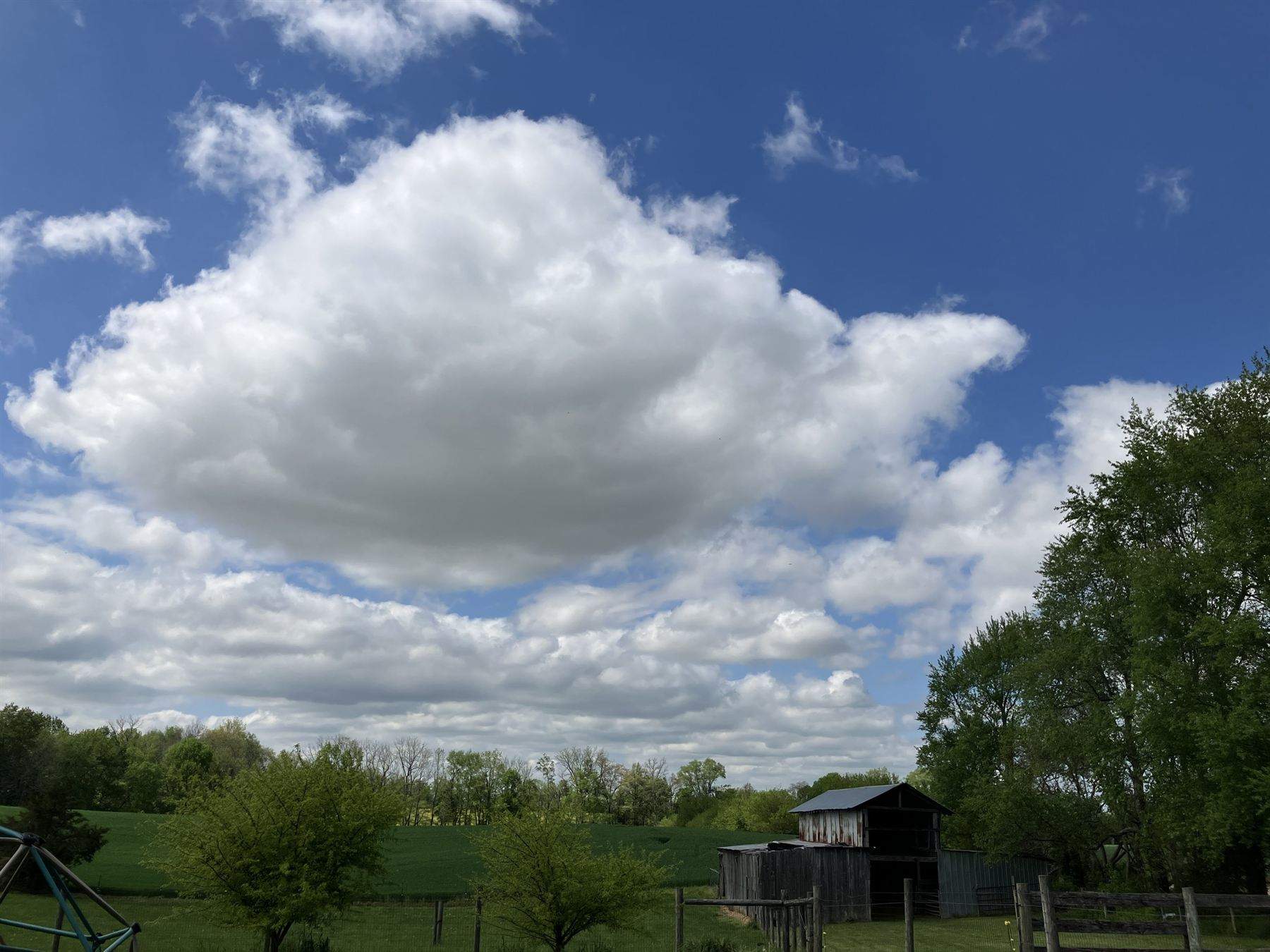 Tobacco barn and pasture under an open sky